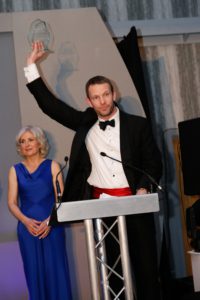 Peter Brewin collecting the award